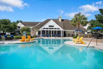 A pool with a building in the background.